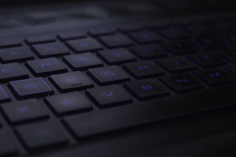 Dark, moody close-up of black keyboard keys with soft lighting.