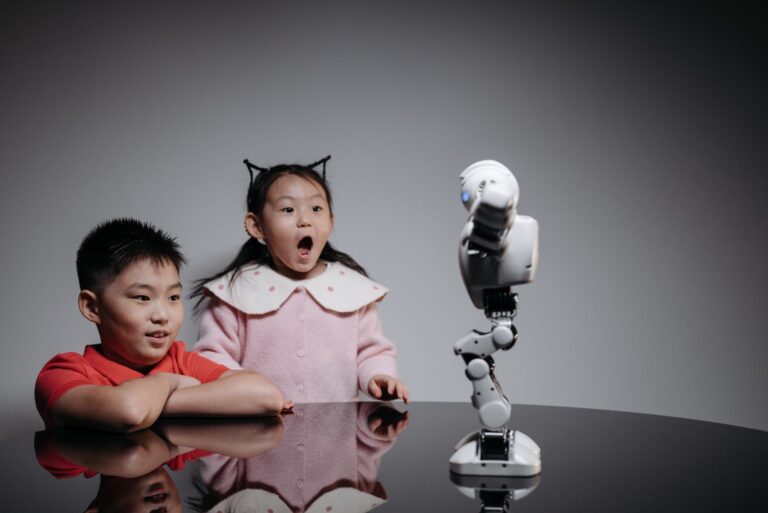 Two children fascinated by a toy robot, showcasing excitement and curiosity indoors.