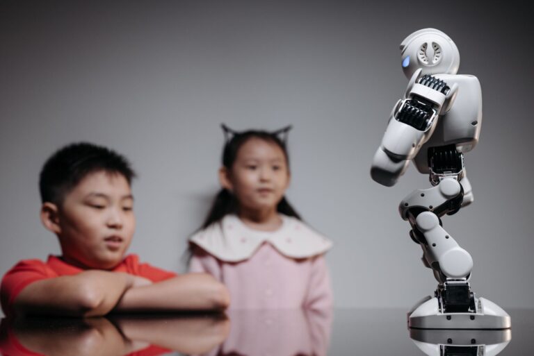 Two children watching and interacting with an innovative robot toy indoors.