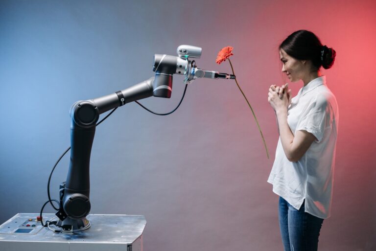 A robotic arm offers a flower to a woman in a display of technology and human connection.